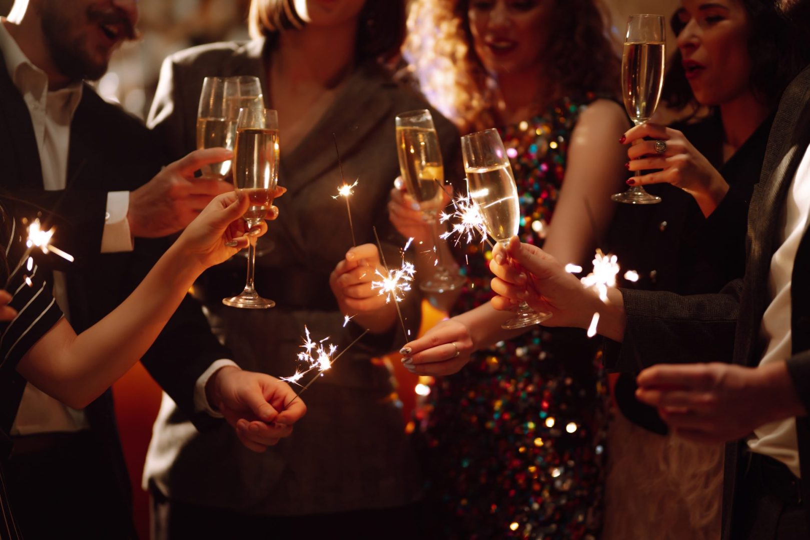 Sparkling,Sparklers,In,The,Hand.,Group,Of,Happy,People,Holding